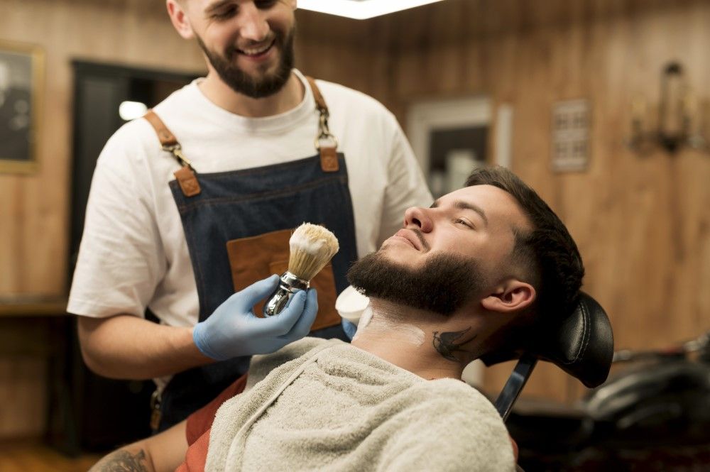 barber-using-shaving-cream-contour-male-customer-s-beard