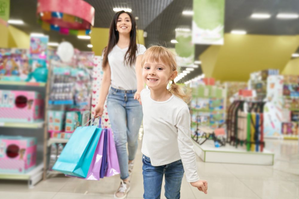 girl-keeping-hand-of-mom-and-running-forwardn-in-toy-store