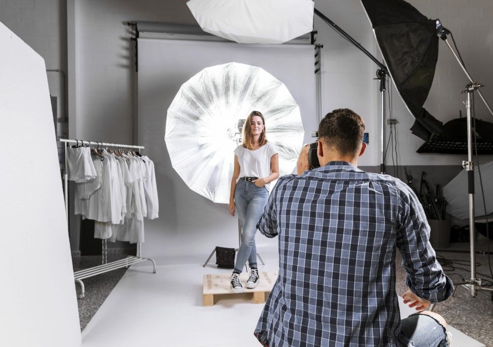 man-taking-photo-woman-model-studio