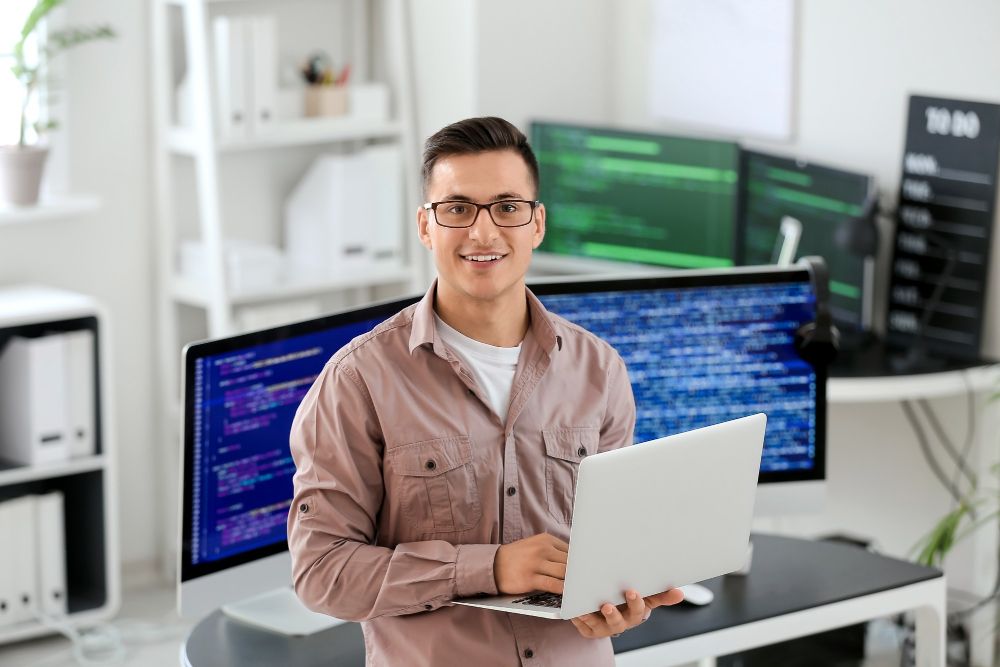 portrait-of-male-programmer-in-office