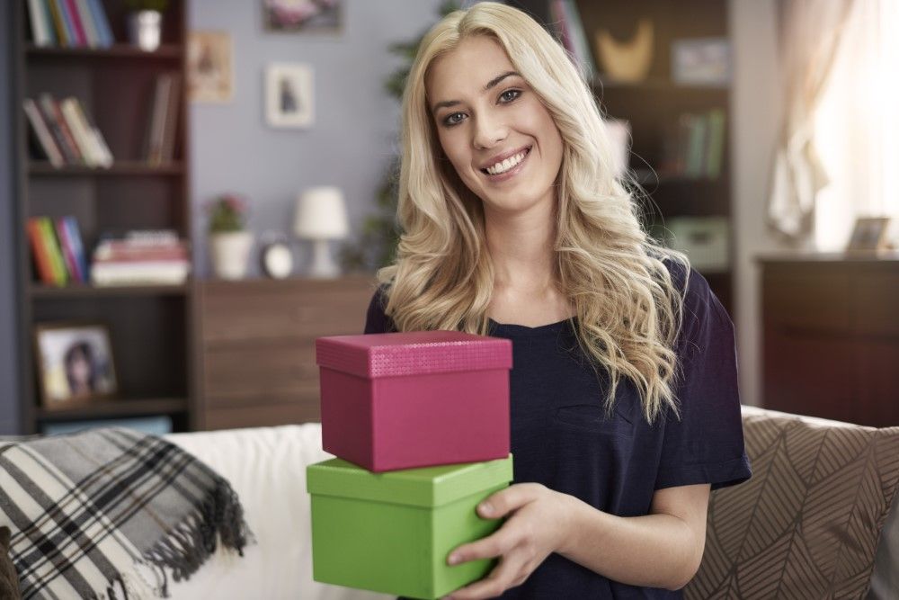 Portrait of smiling woman with small boxes