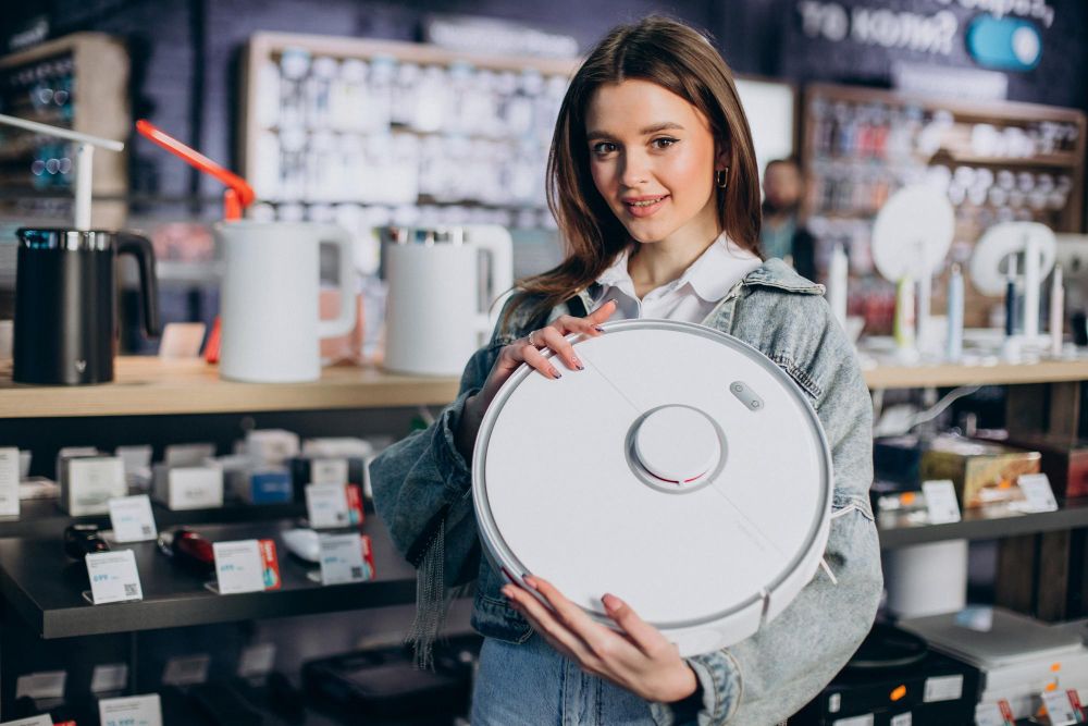 woman-buying-wireless-vacuum-cleaner-at-store