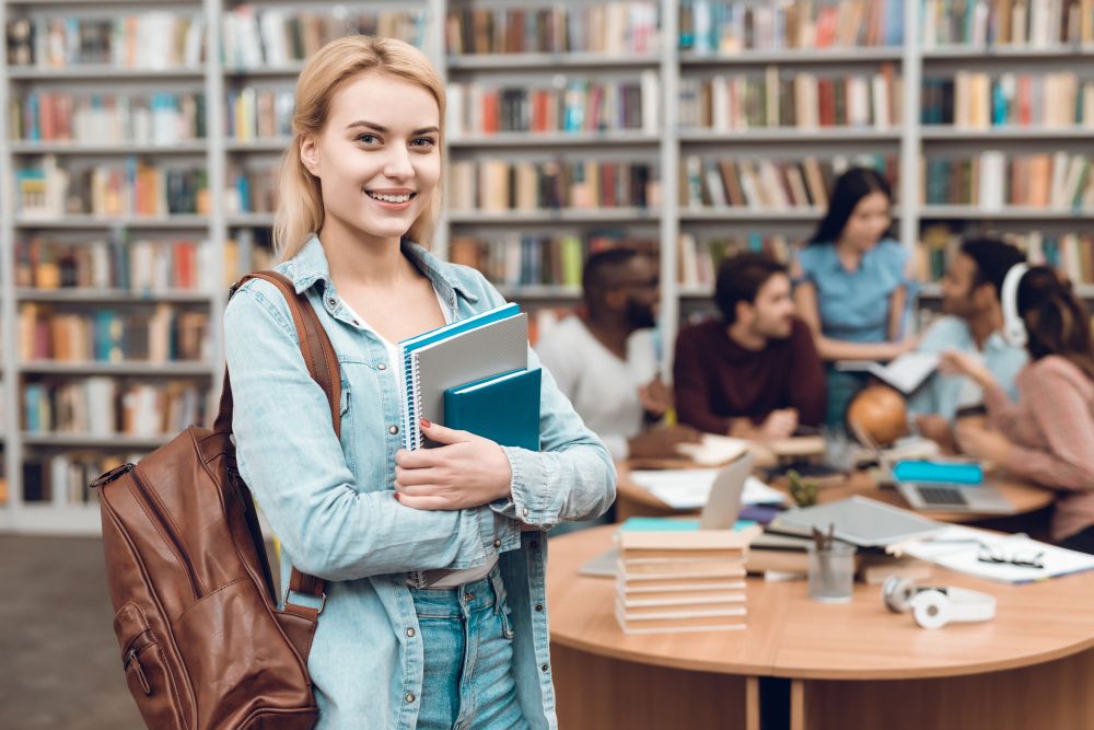 group-of-ethnic-multicultural-students-sitting-in-library
