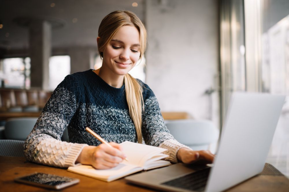 student-studying-using-laptop-computer-online-education-beautiful-woman-freelancer-writes-notes-planning-working-project-working-from-home